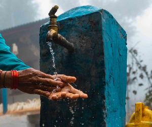 local person washing hands at a water stand in Ethiopia