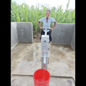 local woman at a hand pump
